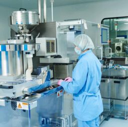 pharmacy-worker-operating-a-deblister-machine-at-work