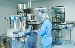 pharmacy-worker-operating-a-deblister-machine-at-work